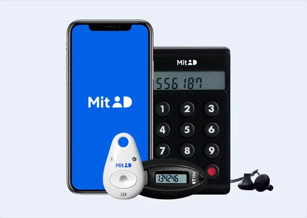 A smartphone with the Mit ID logo, a numeric keypad device, two authentication tools, and earphones on a light background.