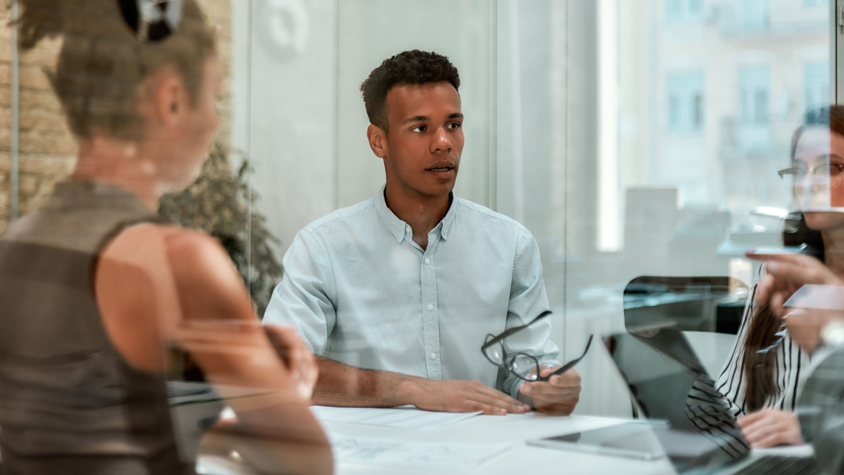 business-expert-young-afro-american-man-holding-eyeglasses-explaining-something-his