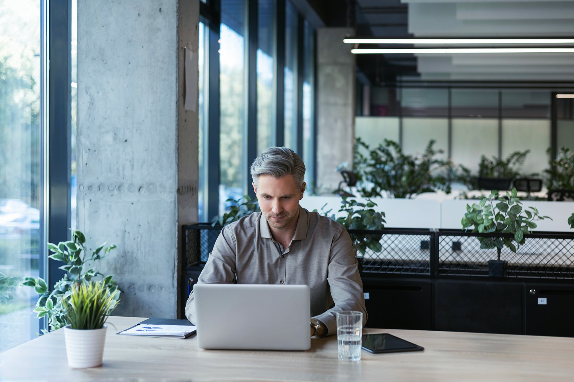 young-handsome-businessman-using-laptop-his-office-desk