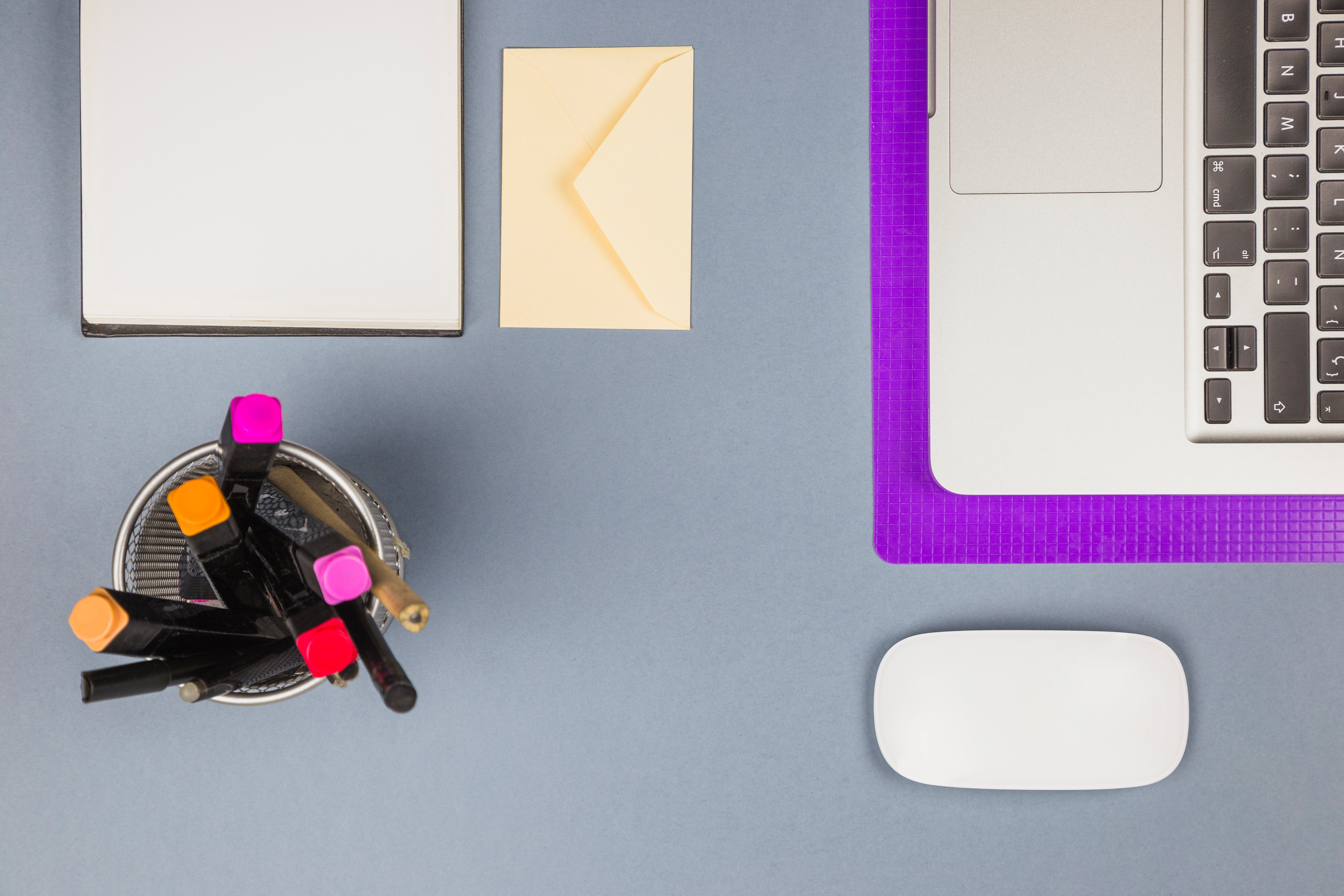 laptop-near-paper-cup-with-felt-pens-letter-computer-mouse