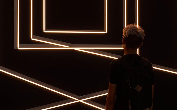 man-fluorescent-light-black-room
